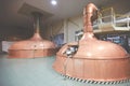 Equipment for preparation of beer. Lines of cooper tanks in brewery. Manufacturable process of brewage. Mode of beer Royalty Free Stock Photo