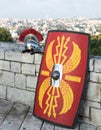 Equipment of a Roman legionary - shield, sword and helmet on the background of Jerusalem