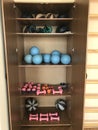 Equipment of the room of therapeutic physical training. In the open case lie dumbbells and balls. Next to the wall is a Swedish wa Royalty Free Stock Photo