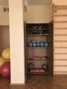 Equipment of the room of therapeutic physical training. In the open case lie dumbbells and balls. Next to the wall is a Swedish wa Royalty Free Stock Photo