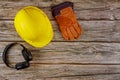 Equipment safety standard construction safety earmuffs leather safety helmet protective gloves on wooden table Royalty Free Stock Photo