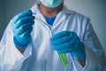 Equipment and science experiments oil pouring scientist with test tube green making research in laboratory. Royalty Free Stock Photo