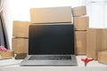 Equipments for SME online business, delivery business laptop, barcode, boxes, checking product on stocks or cardboard parcels.