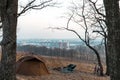 Equipped camp in the forest. Camping tent and portable chairs and table. Cold autumn day. outdoor. nobody. bonfire and bicycle, Royalty Free Stock Photo