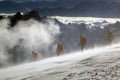 Equipped climber ascent by snowy slope with climbing rope on the top of peak in snowy alpine mountains. Life guard professional ma Royalty Free Stock Photo