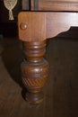 Turned solid wood table leg of an antique billiards, snooker or pool table Royalty Free Stock Photo