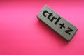 eraser with the inscription & x22;ctrl + z& x22; on a pink background Royalty Free Stock Photo
