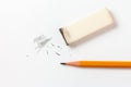 Eraser with traces of dust and a pencil on a white sheet Royalty Free Stock Photo