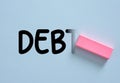 Erasing debt word with pink rubber Royalty Free Stock Photo