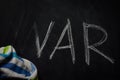 erasing war - rag wiping out the word war written with chalk on a blackboard, concept for ending conflicts Royalty Free Stock Photo