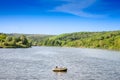 ERDEVIK, SERBIA - JUNE 23, 2023: Inflatable dighy boat with people over Jezero bruje, or lake bruje, in Fruska Gora, in Serbia, in