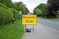 Erected traffic Diversion Sign seen in at the beginning of a village high street. Royalty Free Stock Photo