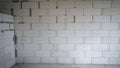 The erected wall of modern building brick - foam block. Bricklayer builder working with autoclaved aerated concrete Royalty Free Stock Photo