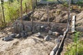 Erecting a field stones wall using wooden formwork