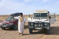 ERG CHIGAGA, MOROCCO - OCTOBER 21 2020: Tourists cars and the moroccan guide in the desert, Africa.