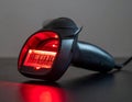 Ergonomic black barcode scanner with bright red scanning light and illuminated barcode handheld scanner Royalty Free Stock Photo