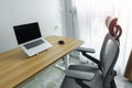 Ergonomic chair and Adjustable table with laptop computer in modern workplace. Good posture to avoid Office syndrome, Back Pain,