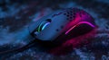 Sleek Computer Mouse with RGB Lighting on Textured Dark Surface Royalty Free Stock Photo
