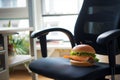 ergonomic office chair with a fish burger resting on the armrest