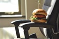 ergonomic office chair with a fish burger resting on the armrest