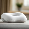 Ergonomically designed white memory foam pillow with a contoured shape, sitting on Royalty Free Stock Photo