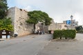 Group of tourists near the entrance to the medieval Venus Castle in historic town Erice.