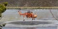 Erickson Air Crane helicopter N243AC Sikorsky S-64E sucking up a load of water to fight a bushfire in the Melbourne suburb of Bu