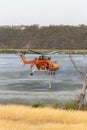 Erickson Air Crane helicopter N243AC Sikorsky S-64E sucking up a load of water to fight a bushfire in the Melbourne suburb of Bu