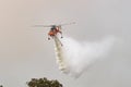 Erickson Air Crane helicopter Sikorsky S-64 N243AC dropping a large load of water onto a bushfire in support of fire fighting ef Royalty Free Stock Photo