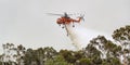 Erickson Air Crane helicopter Sikorsky S-64 N243AC dropping a large load of water onto a bushfire in support of fire fighting ef Royalty Free Stock Photo