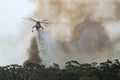 Erickson Air Crane helicopter Sikorsky S-64 N243AC dropping a large load of water onto a bushfire in support of fire fighting ef Royalty Free Stock Photo