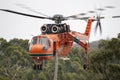 Erickson Air Crane helicopter taking off after filling with a load of water to fight a fire. Royalty Free Stock Photo