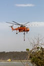 Erickson Air Crane helicopter taking off after filling with a load of water to fight a fire Royalty Free Stock Photo