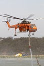 Erickson Air Crane helicopter taking off after filling with a load of water to fight a fire Royalty Free Stock Photo