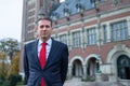 Erik de Baedts, posing for a portrait in front of the peace palace