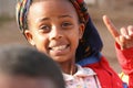 An Eritrean girl makes the sign with her index finger and looks towards the camera, on the outskirts of Asmara, Eritrea.