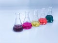 The Erlenmeyer or Conical flask on bench laboratory, with colorful solvent solution from titration experiment, acidity, alkalinity Royalty Free Stock Photo