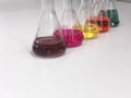 The Erlenmeyer or Conical flask on bench laboratory, with colorful solvent solution from titration experiment, acidity, alkalinity Royalty Free Stock Photo