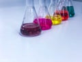 The Erlenmeyer or Conical flask on bench laboratory, with colorful solvent solution from titration experiment, acidity, alkalinity Royalty Free Stock Photo