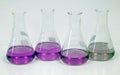 The Erlenmeyer or Conical flask on bench laboratory, with green-purple solvent forming reaction between boric acid and ammonia.