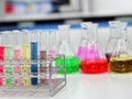 The Erlenmeyer conical Flasks and test tubes with rack on bench laboratory, with colorful solvent for testing indicator, titration Royalty Free Stock Photo