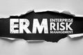 ERM Enterprise Risk Management text under torn paper. Business corporate concept highlighting control, security, planning, Royalty Free Stock Photo
