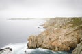 Eroded Ciffs on a wild coast, foggy day