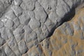 Eroded grey rock texture with some sand Royalty Free Stock Photo