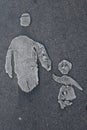 eroded painted sign of pedestrians on concrete: an adult parent (mother or father) walking together with her, his child