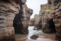 eroded rock formations around sea cave entrance Royalty Free Stock Photo