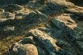 Eroded rocks with green grass on sunset