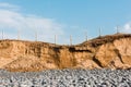 Eroded sand on uk beach showing erosion caused by rising sea levels on coastline Royalty Free Stock Photo