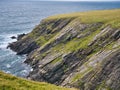 Eroded strata in sea cliffs on the west coast of St Ninian`s Isle on the west coast of the south of Mainland Shetland, UK. Royalty Free Stock Photo