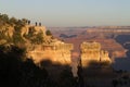 Grand Canyon tourists on rocks at sunrise